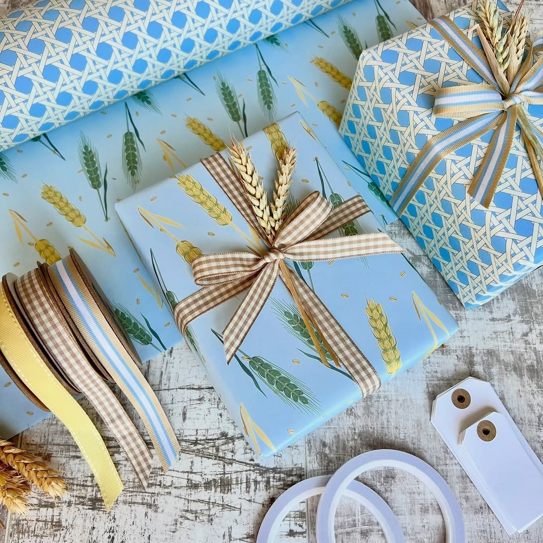 Gift wrapping supplies flat lay with paper, ribbon and tags, from our diy gift basket guide