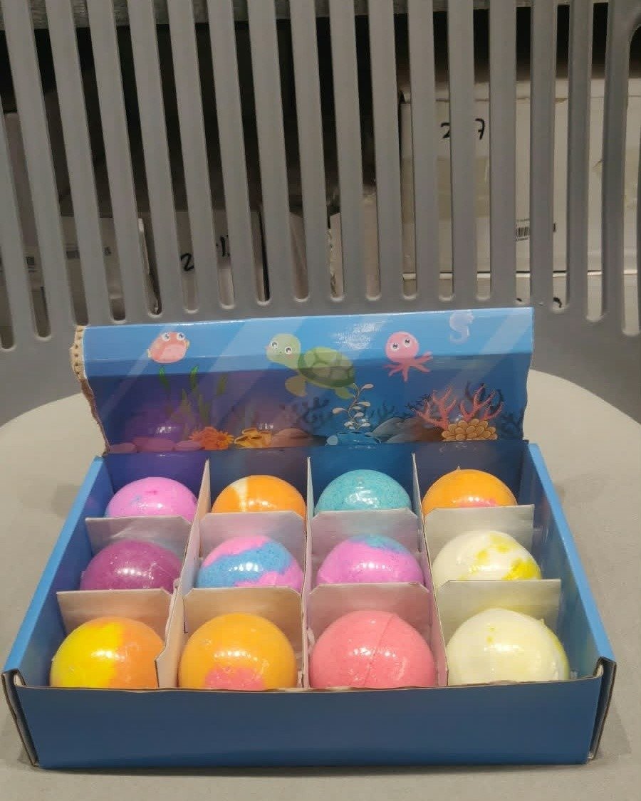 Colorful bath bombs in open gift box
