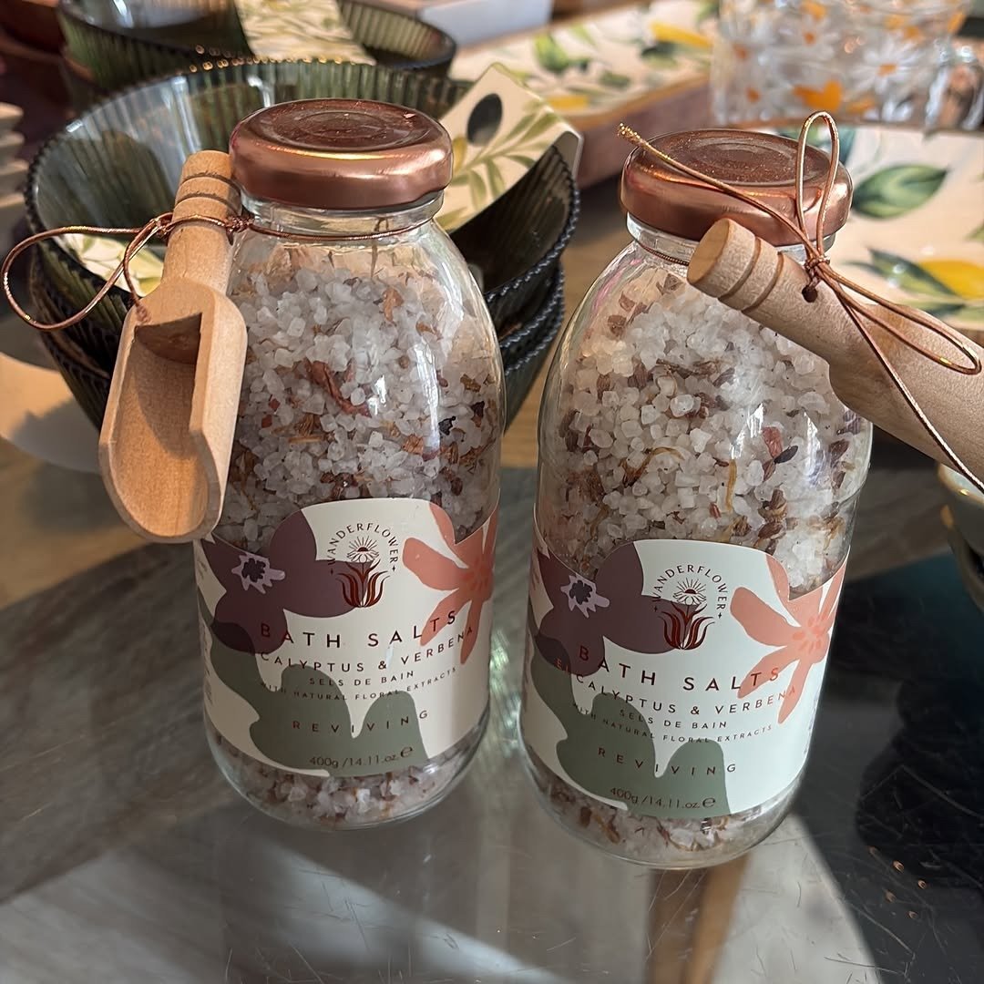 Glass jars of bath salts with wooden scoops
