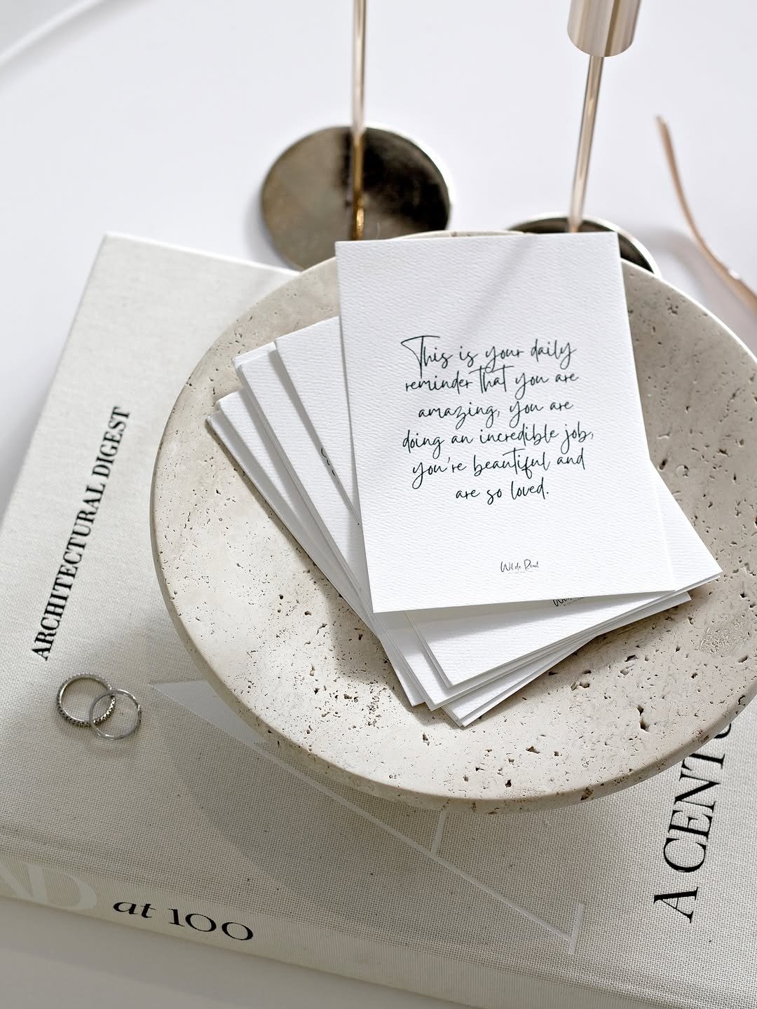 Affirmation cards fanned on stone tray