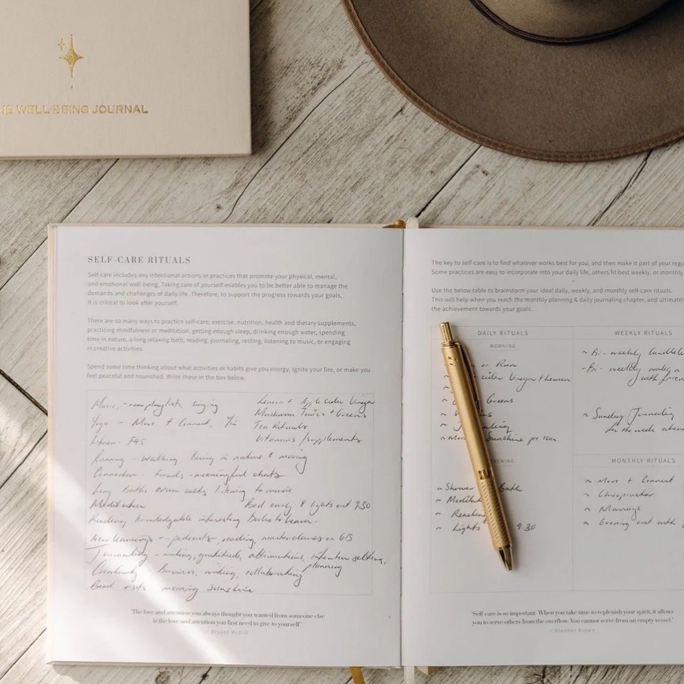 Open wellbeing journal with gold pen