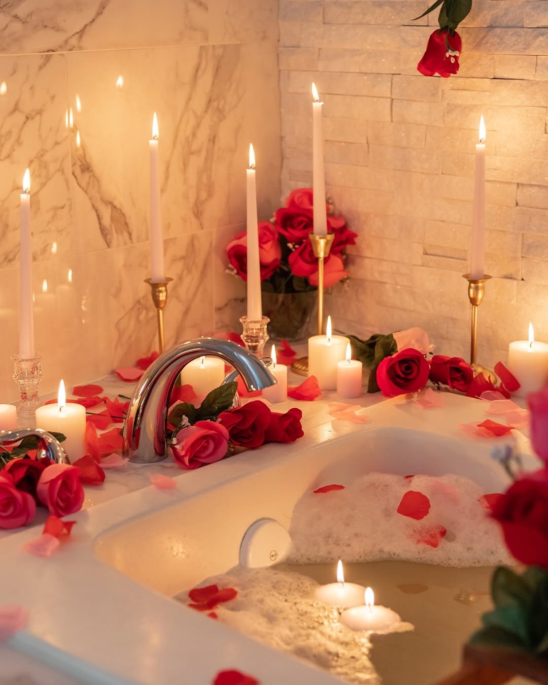 Bubble bath with candles and rose petals, from our self-care gifts for girlfriend guide