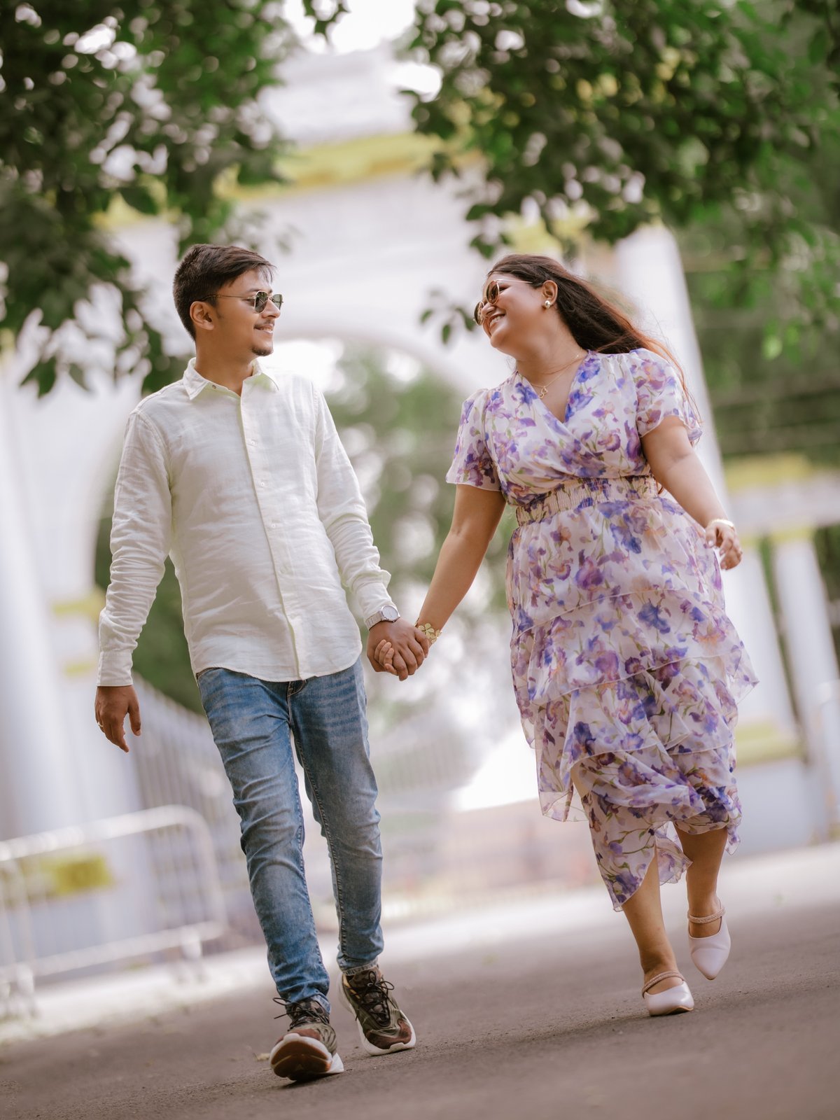 Couple walking outdoors holding hands and talking