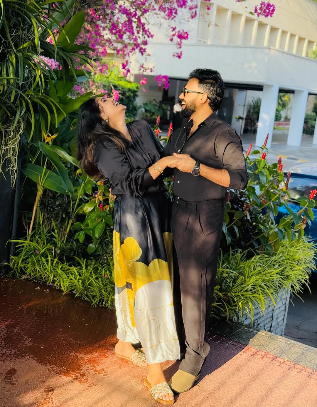Couple laughing joyfully together in a garden