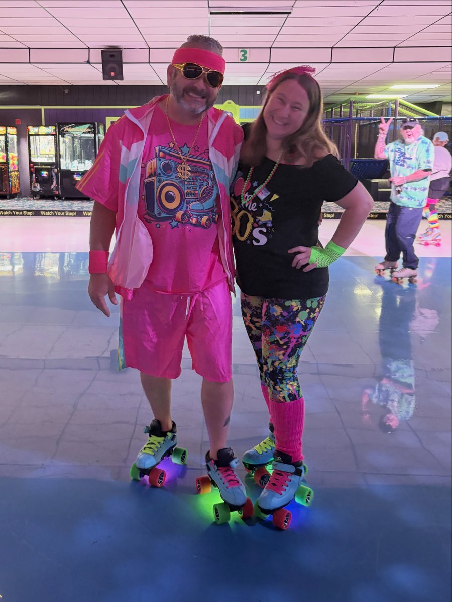Couple roller skating together at an indoor rink