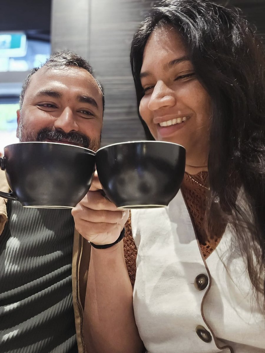 Smiling couple with coffee cups at a cafe
