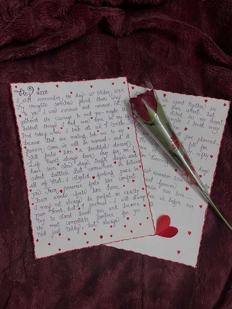 Handwritten love letter decorated with hearts and a rose