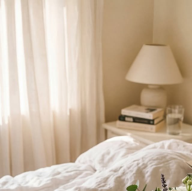 Breakfast tray with coffee, croissants and flowers in bed