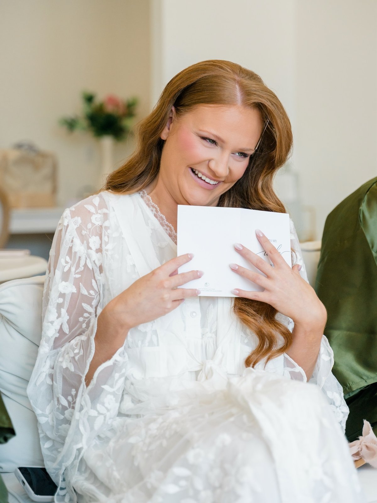 Bride in white lace reading a handwritten love letter