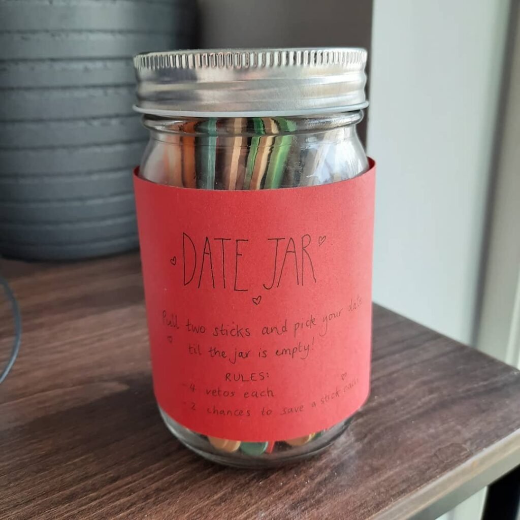 Decorated mason jar filled with colorful date night popsicle sticks