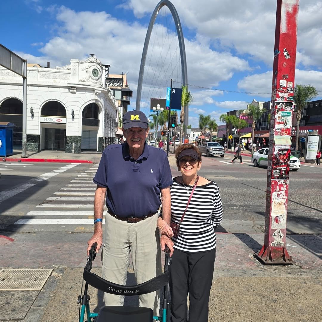 Couple posing on a street with an arch during a food tour