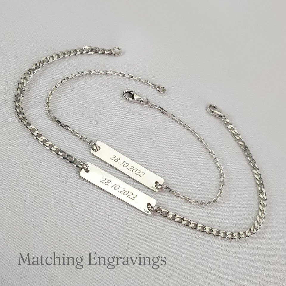 Two engraved bar bracelets side by side