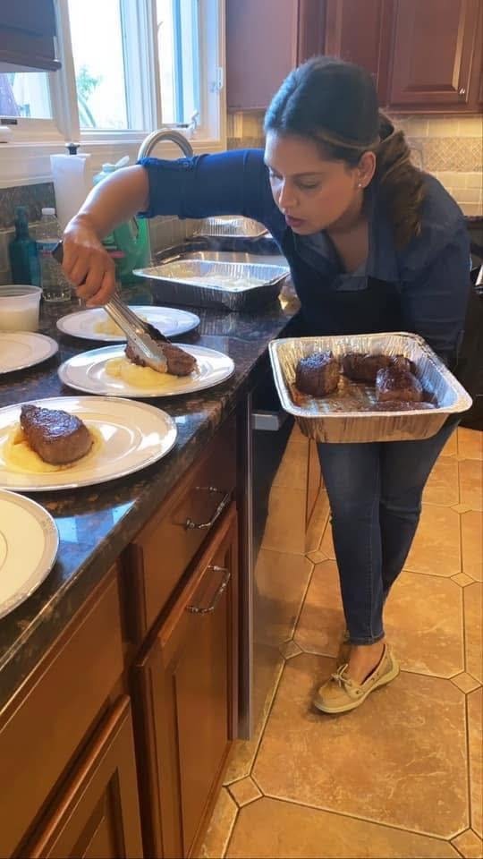 Private chef plating dinner in home kitchen