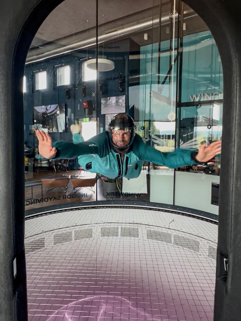 Person floating in indoor skydiving wind tunnel
