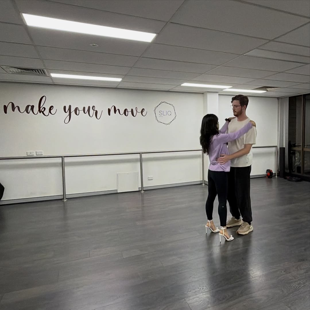 Couple partner dancing in studio