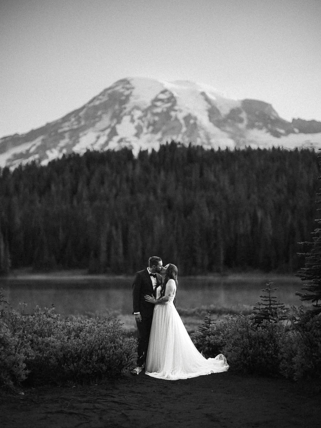 Couple kissing at Mt Rainier National Park lake at sunrise