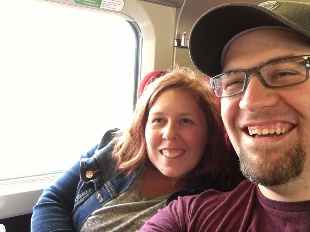 Couple selfie in train window seats