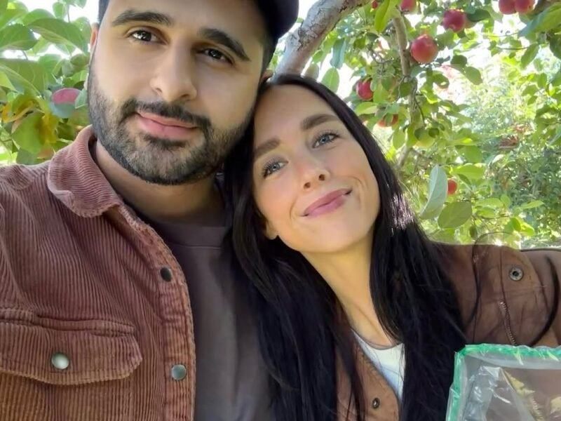 Couple selfie in pumpkin patch at golden hour
