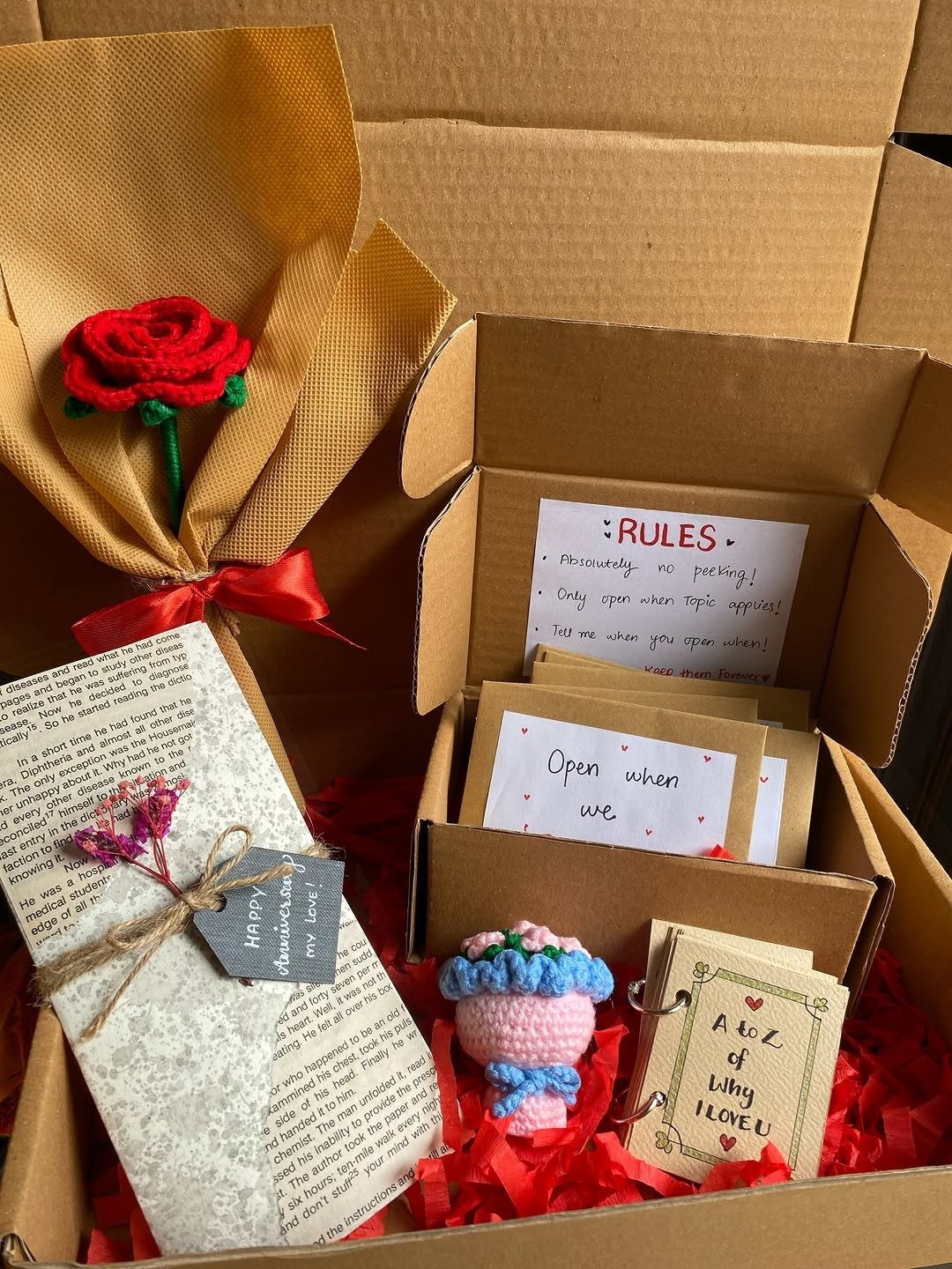 Open DIY gift box with handmade cards and wrapped parcel