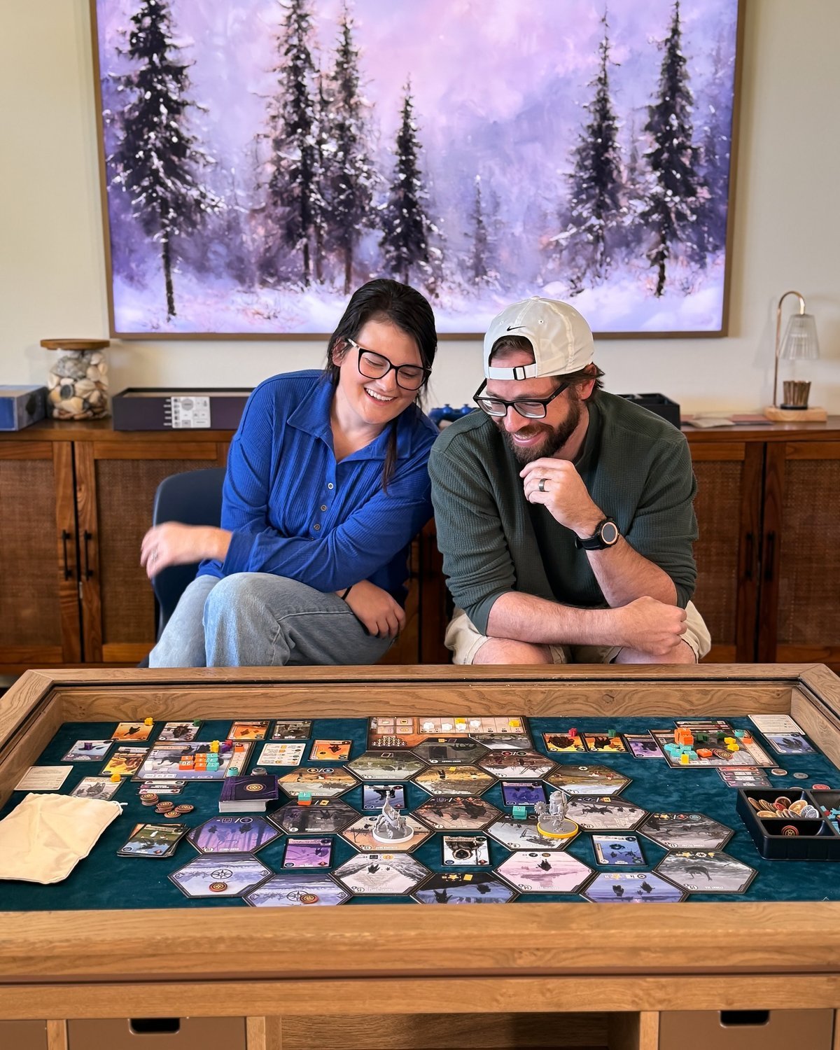 Couple playing a board game at home and laughing