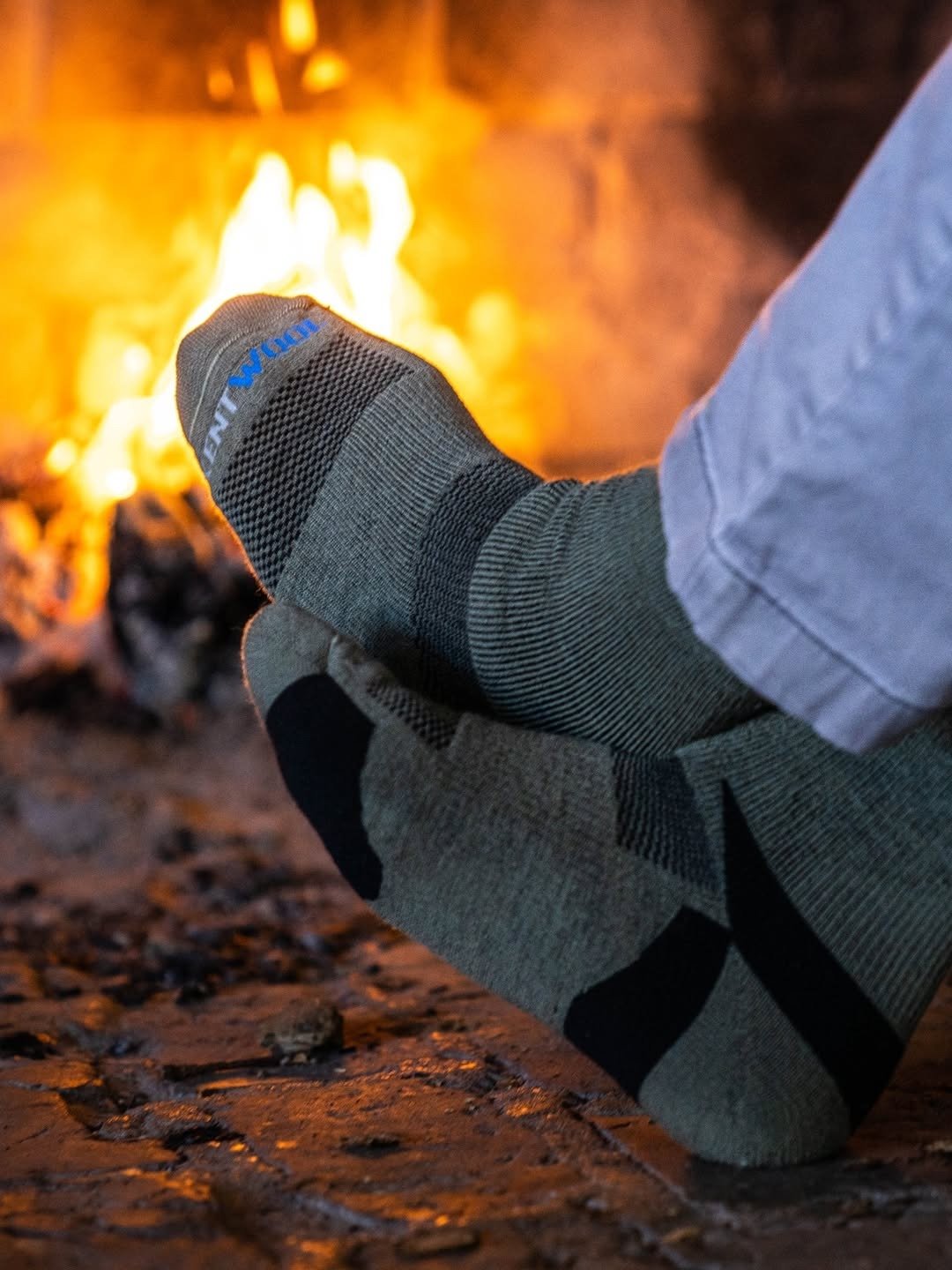Wool socks on feet by an open fireplace