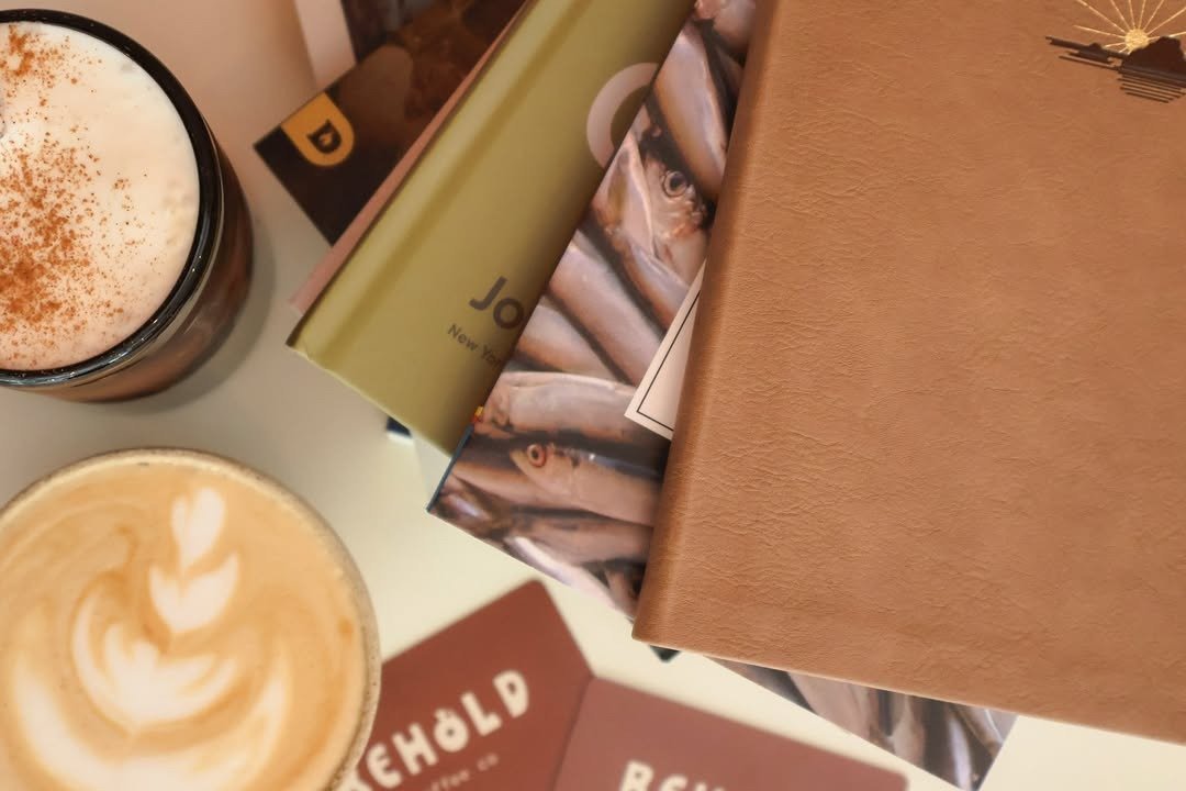 Books and gift cards flat lay on cafe table