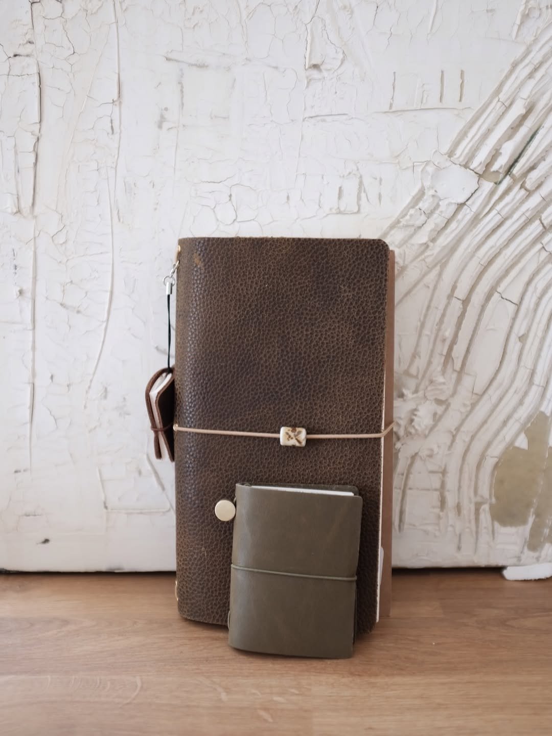 Leather-bound journals standing on light background