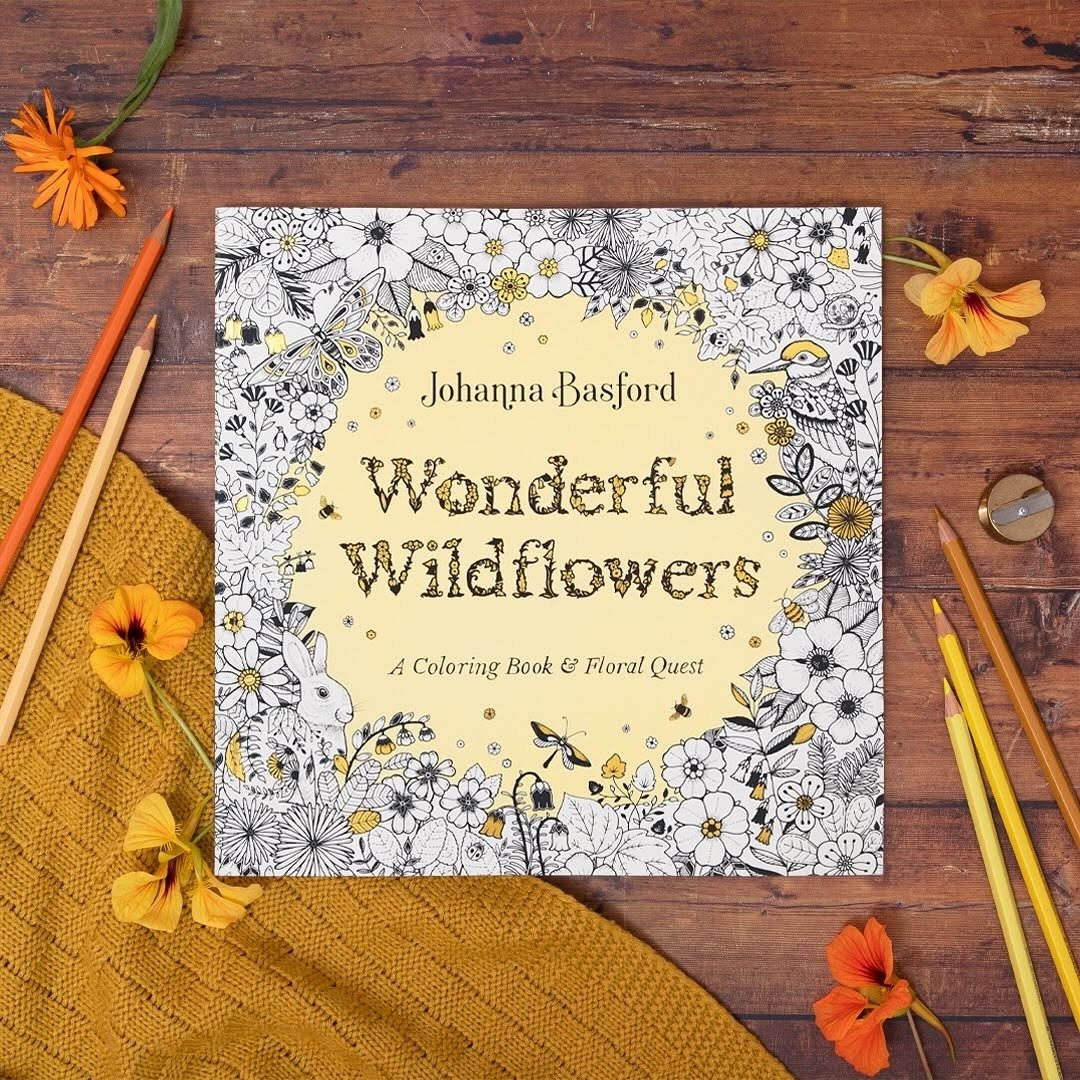 Adult coloring book with colored pencils and flowers
