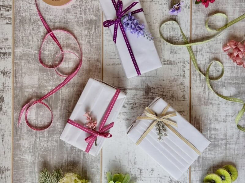 Elegant flat lay of ribbon-tied gift boxes on rustic table