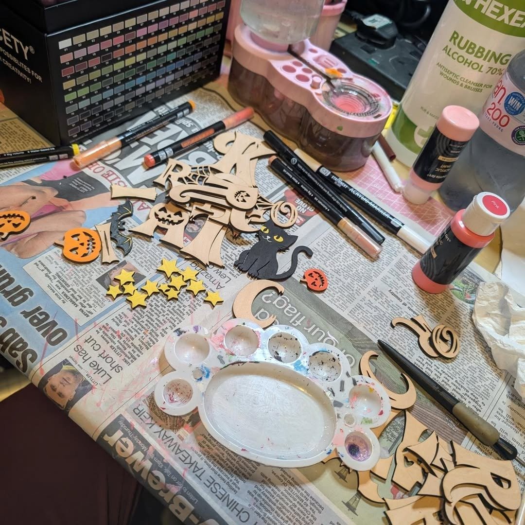 Messy craft table with paints and half-finished projects