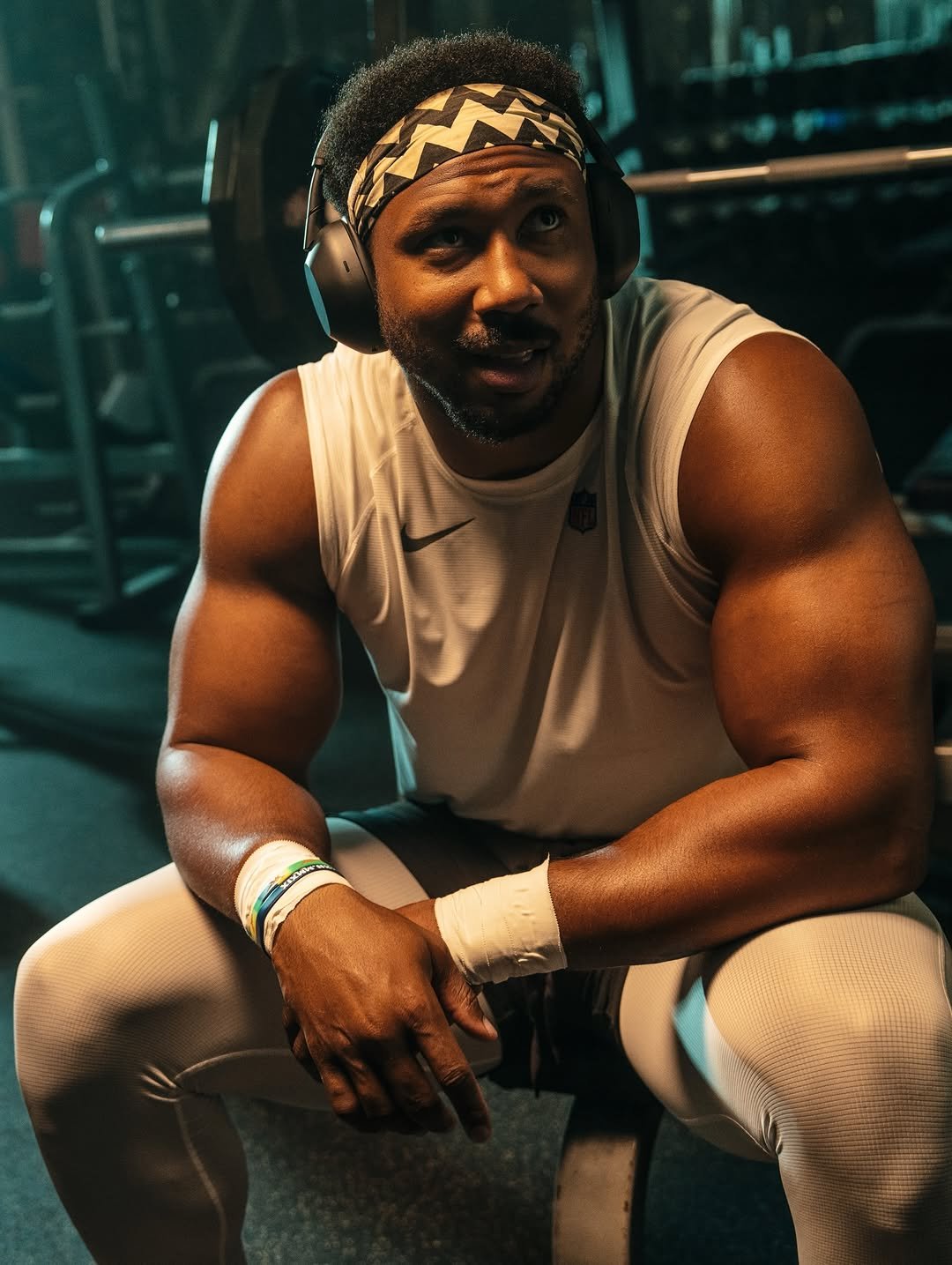 Man wearing black over-ear headphones at the gym
