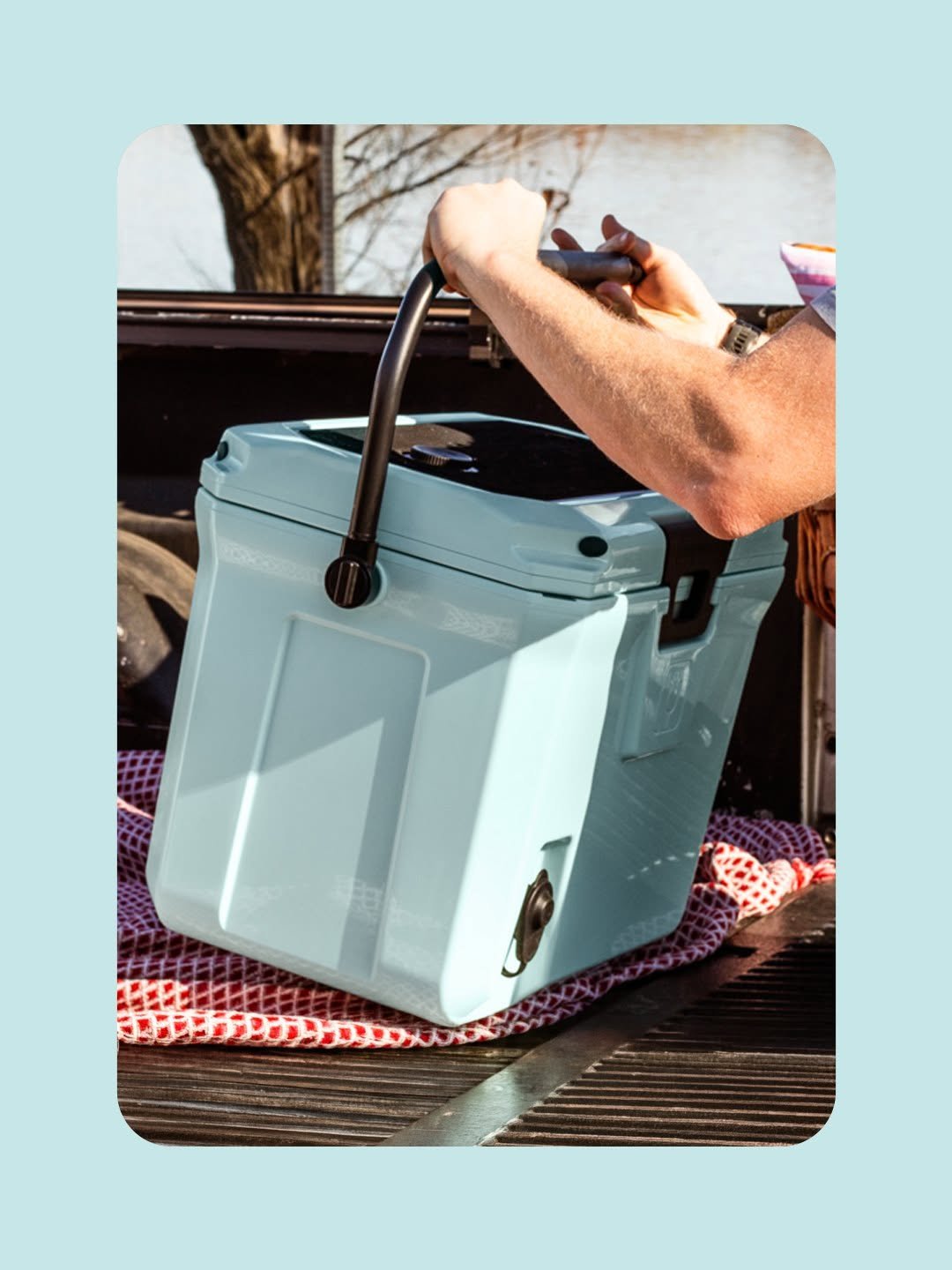 Insulated cooler in pickup truck bed at tailgate