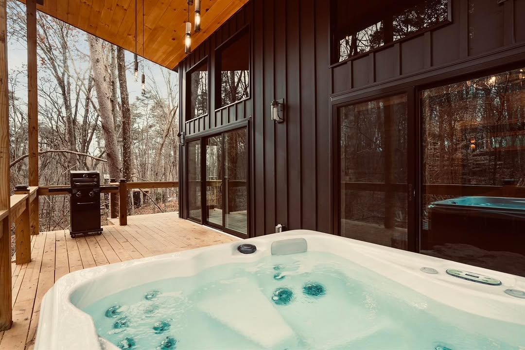 Cabin deck with hot tub among trees