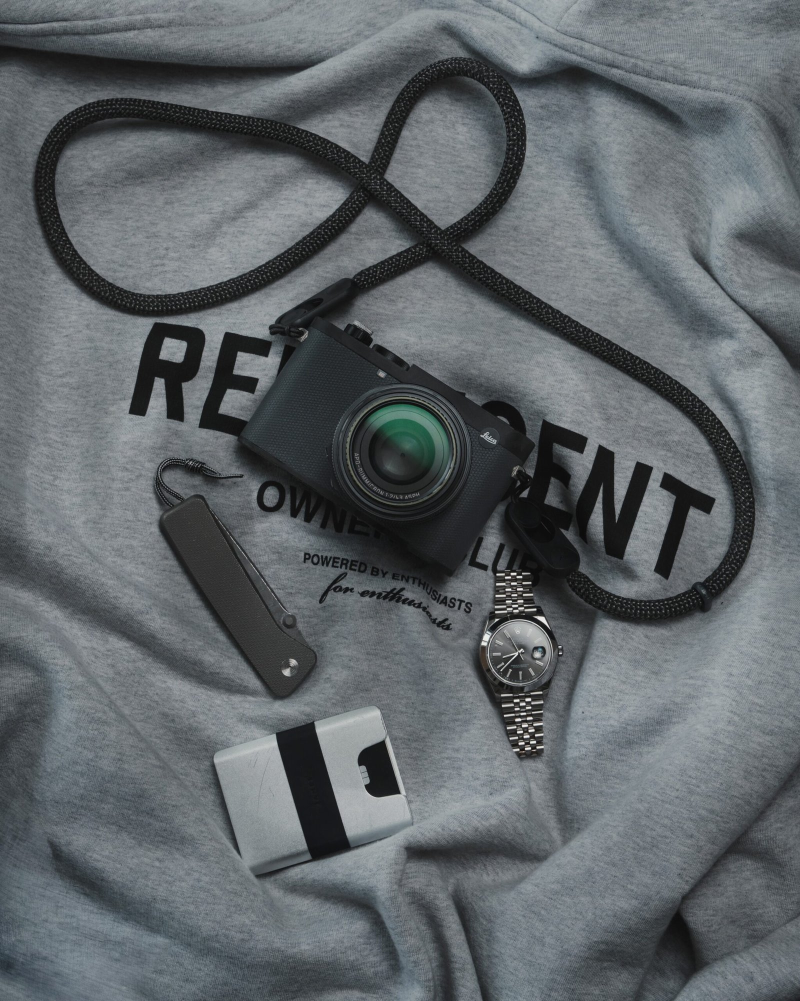 Everyday carry flat lay with wallet, knife and watch