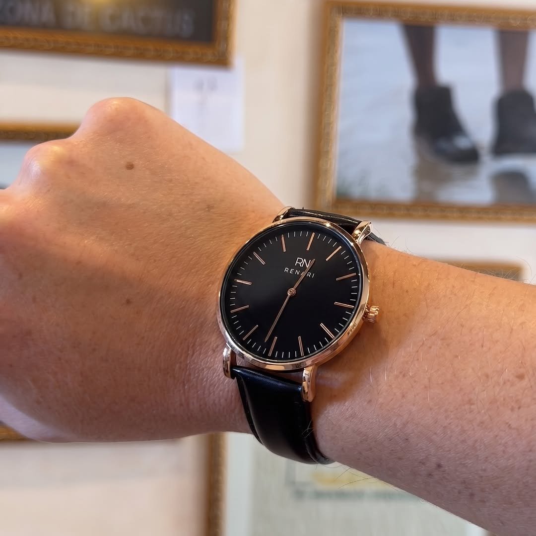 Minimalist watch with black dial on a man's wrist