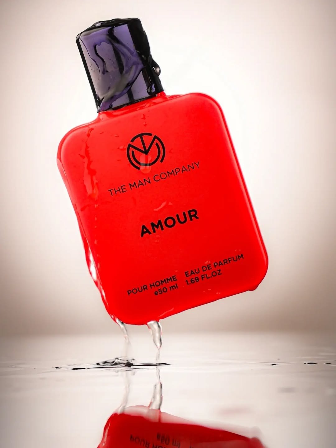 Red cologne bottle on a reflective surface with dark backdrop