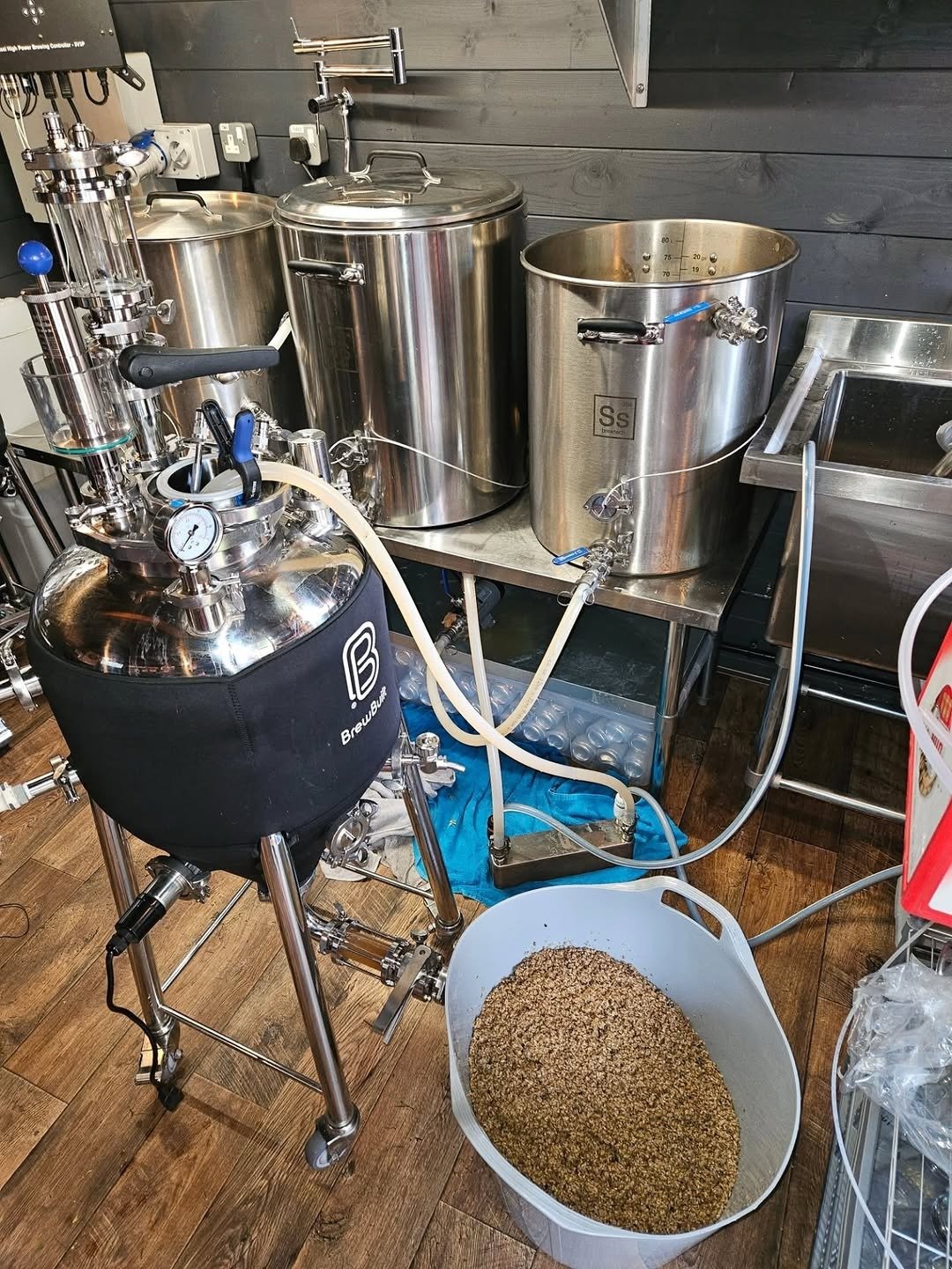 Home brewing setup with fermenter and kettles