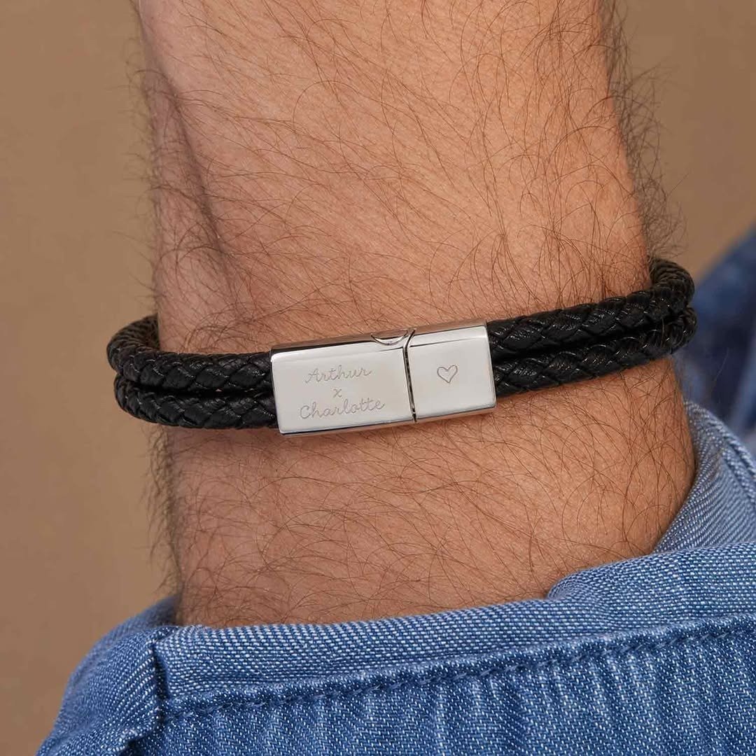 Braided leather bracelet with engraved plate on wrist