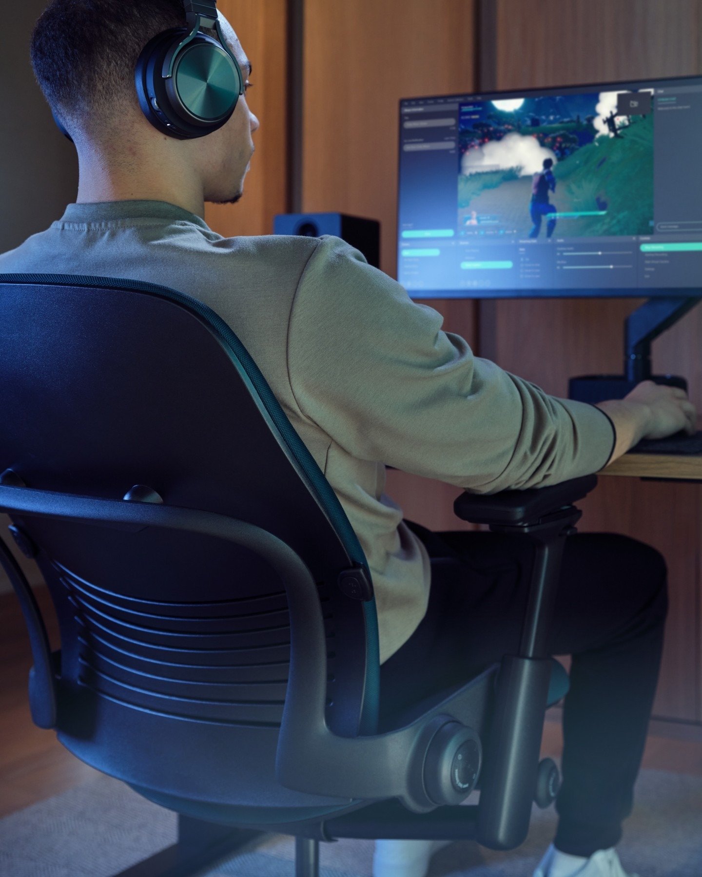 Man wearing gaming headphones at desktop setup (slide 2)