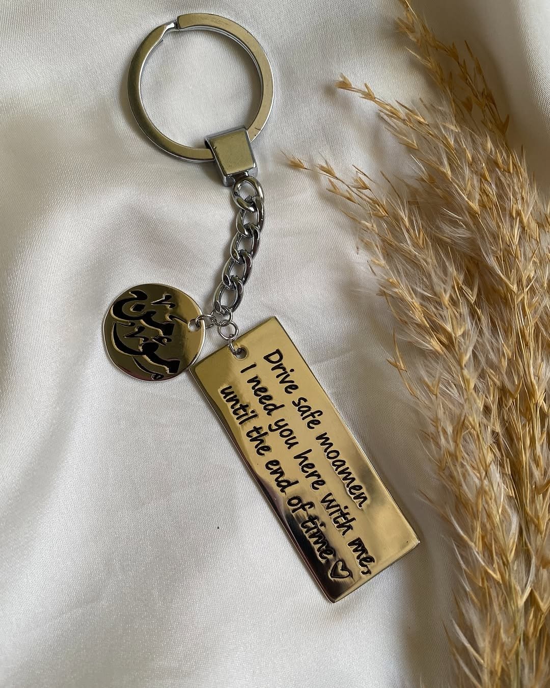 Gold keychain engraved with drive safe message