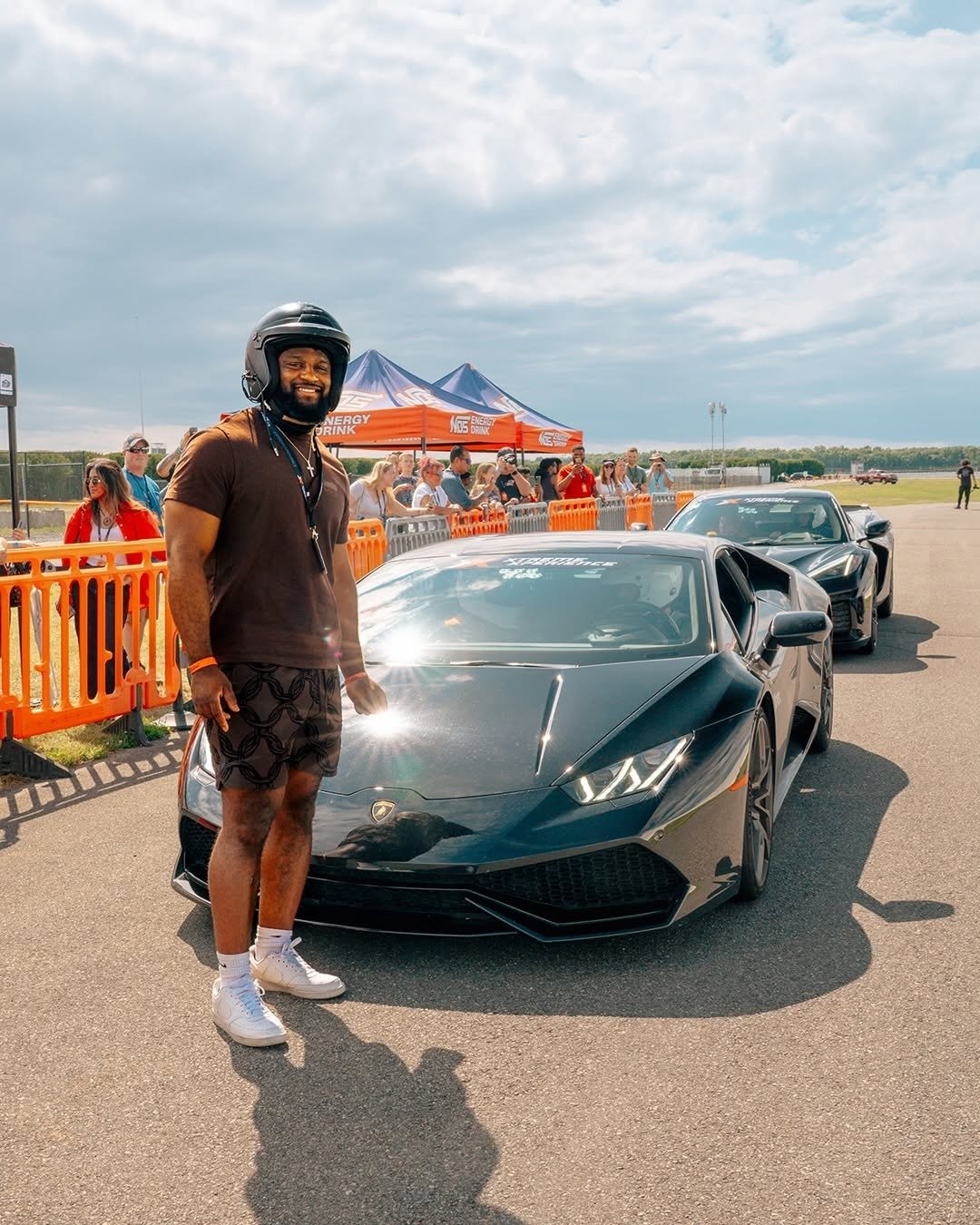 Man in race suit beside Lamborghini on track, from our man who has everything guide