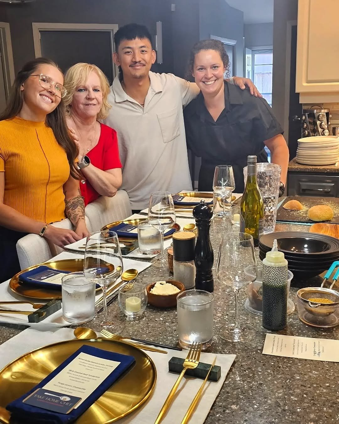 Private chef with guests at set dining table at home