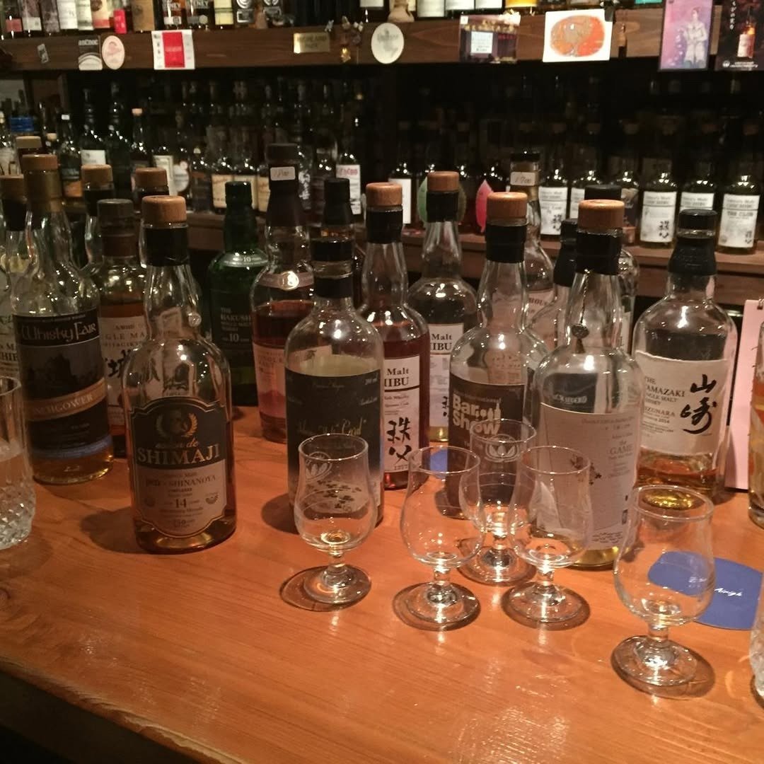 Whisky bottles and tasting glasses on bar counter