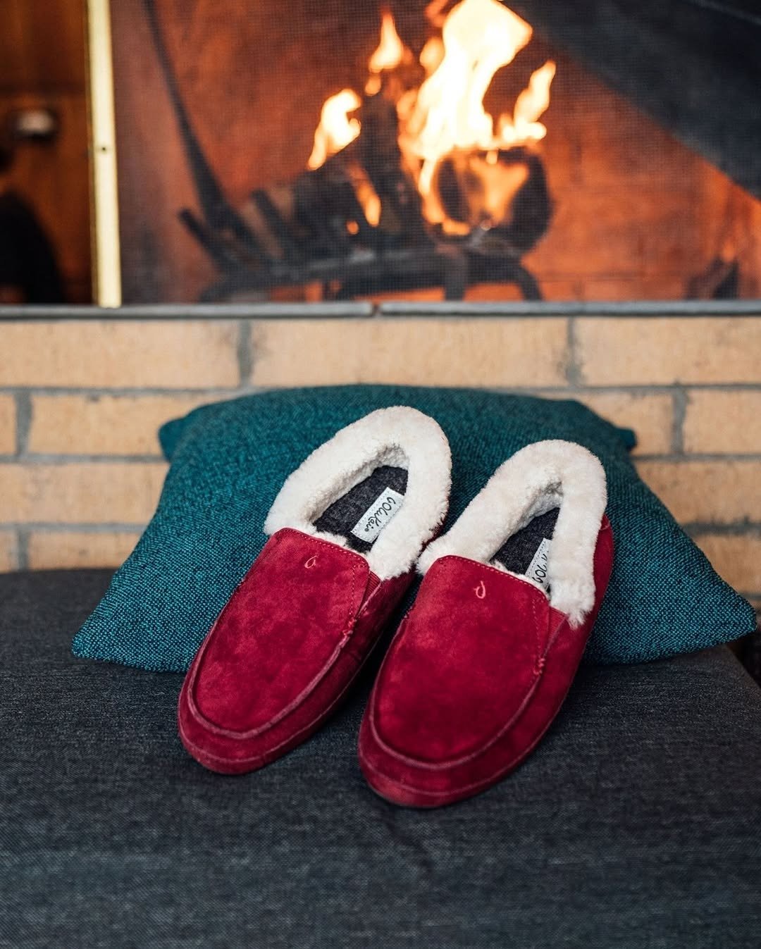 Leather shearling slippers by fireplace