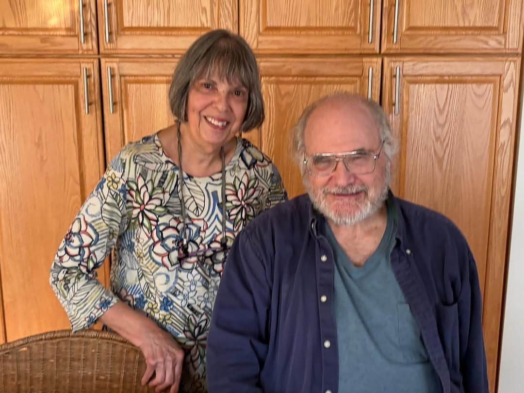 Elderly couple smiling at home celebrating 60th wedding anniversary