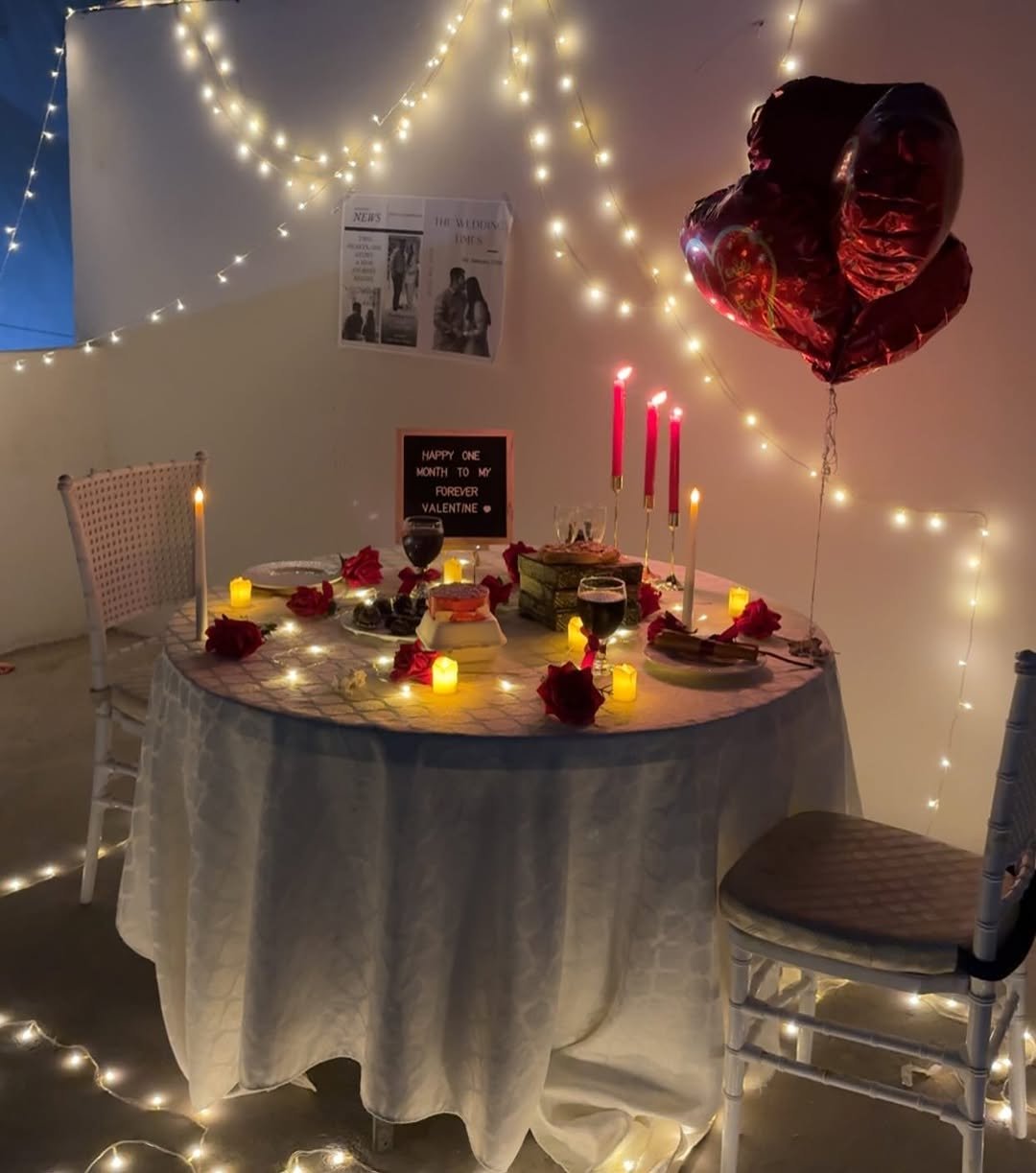Candlelit dinner table for two at home with roses