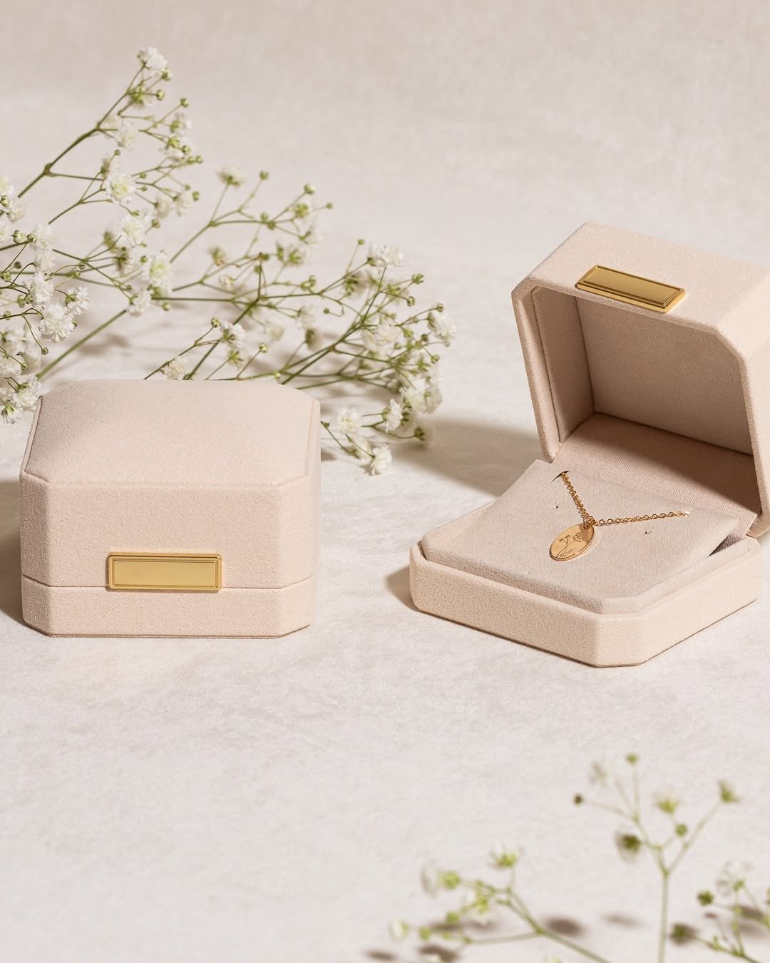 Luxury gift box open showing gold pendant necklace