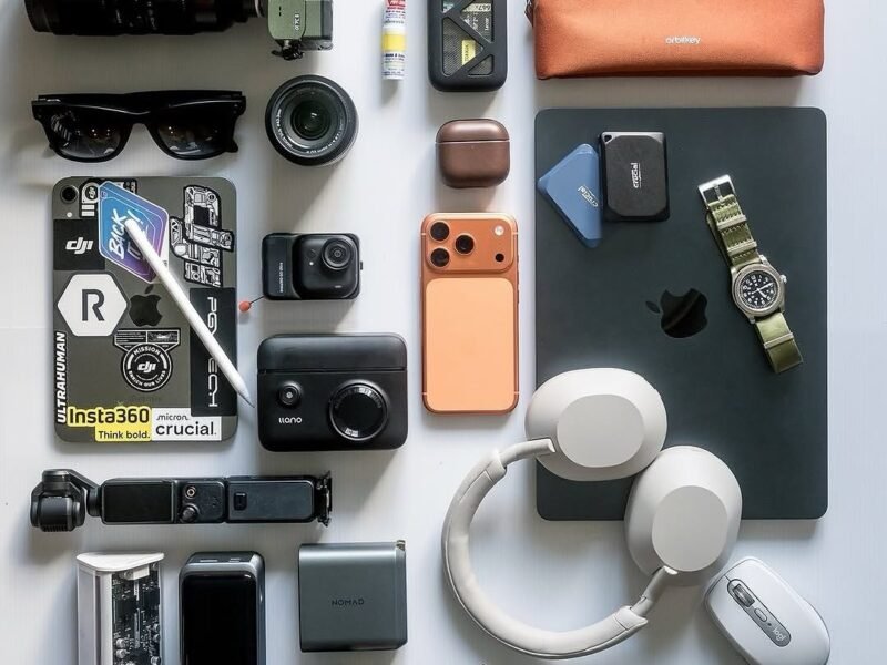Flat lay of headphones, earbuds, watch and phone