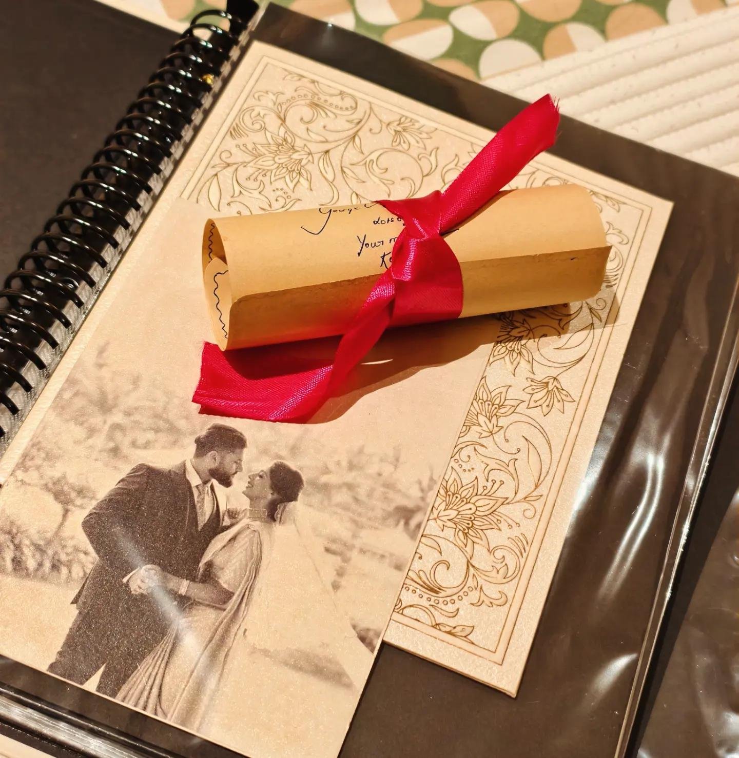 Sealed letter scroll tied with red ribbon on a vow book