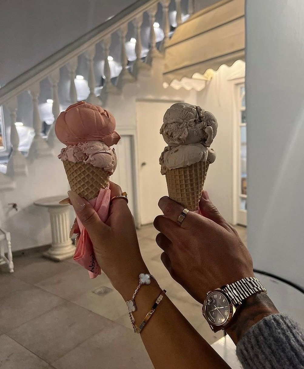 Couple's hands holding pastel ice cream cones